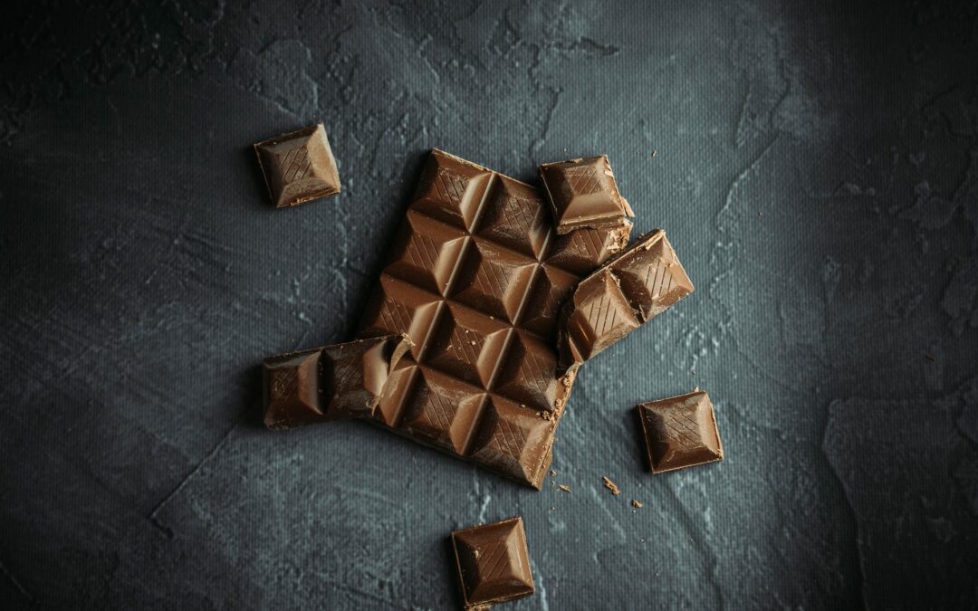 Flat lay food photography of chocolate on black and gray background